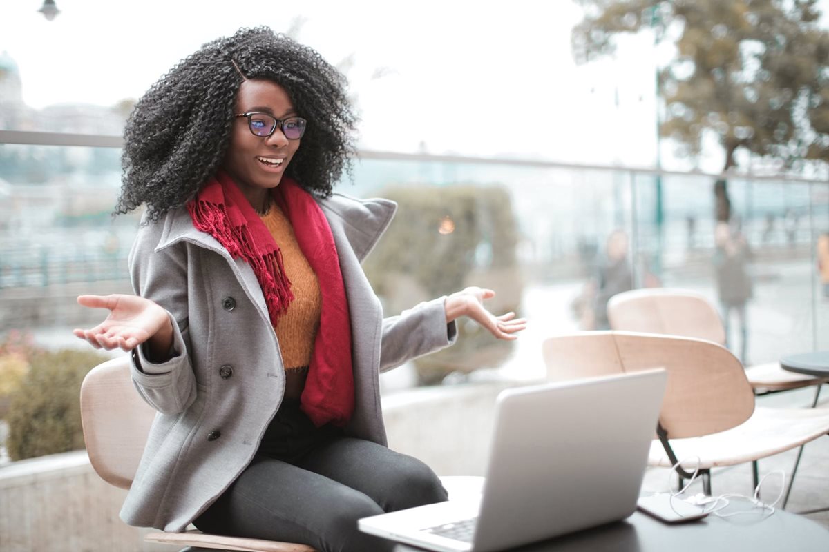Woman excitedly looking at laptop